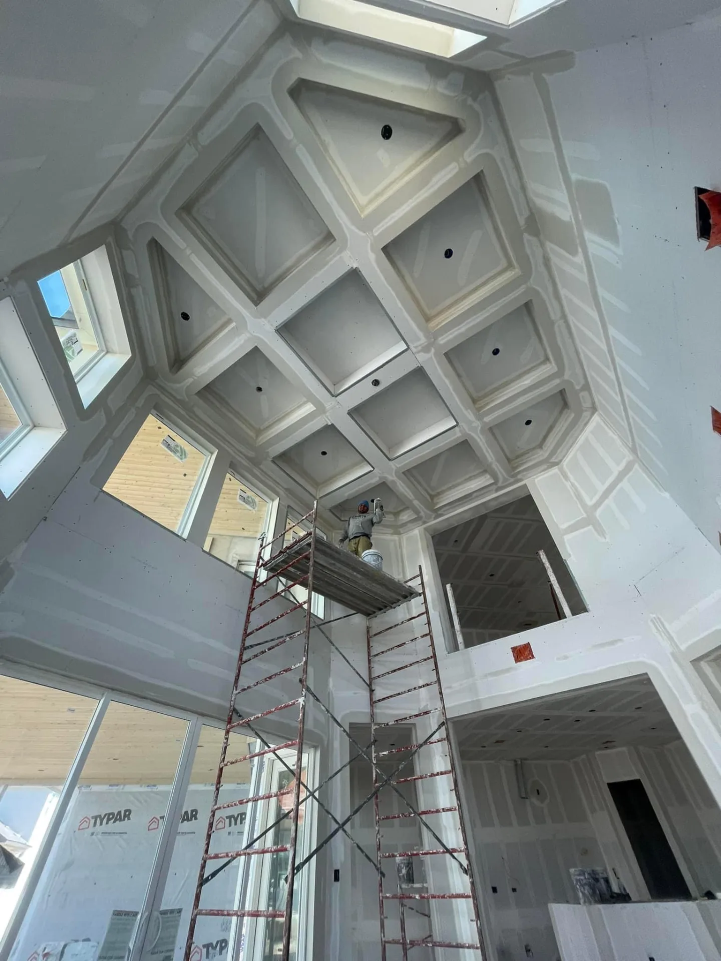 Coffered ceiling with finished drywall boxes and recessed lighting cutouts