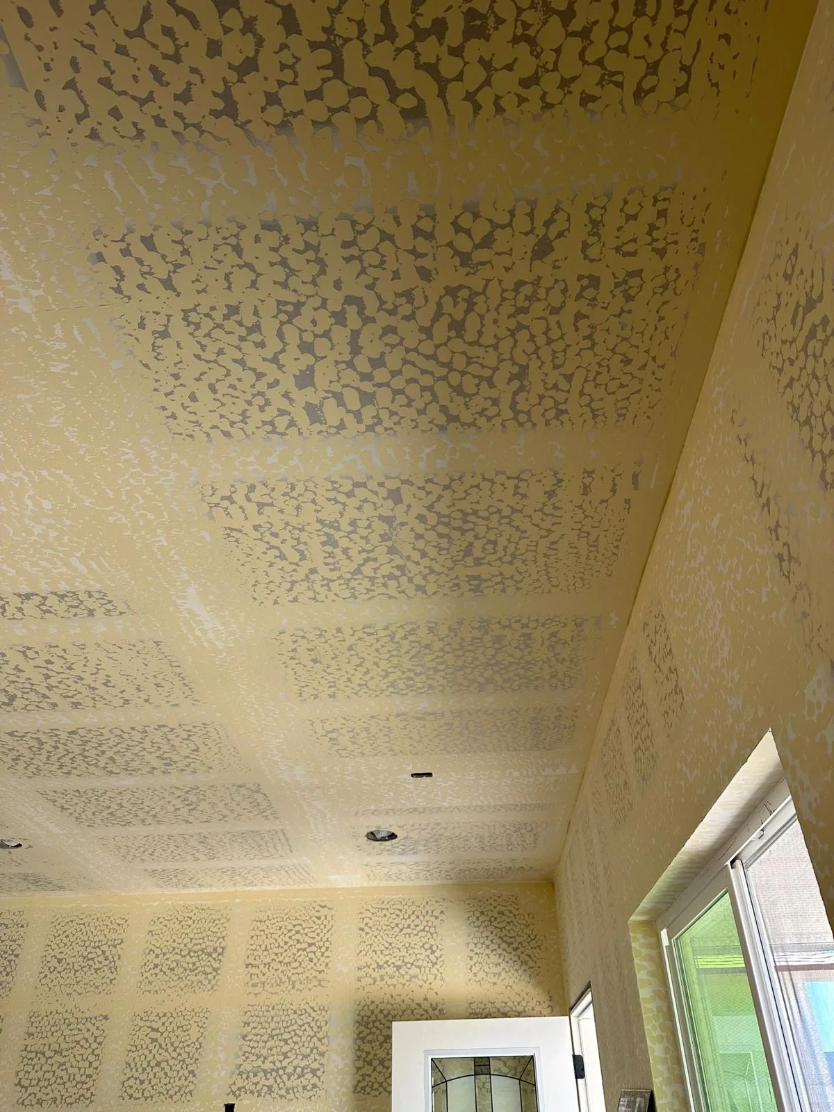 Ceiling and walls showing knockdown texture being applied and matched